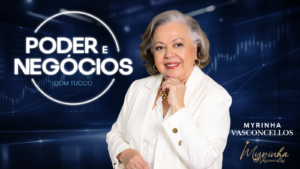 Retrato de Myrinha Vasconcellos sorrindo, vestida de branco, ao lado da identidade visual do programa Poder e Negócios com fundo azul e elementos gráficos de mercado financeiro.